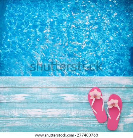 Summer vacation. Pink sandals by swimming pool. Blue sea surface with waves, texture water. Flat mock up for design.