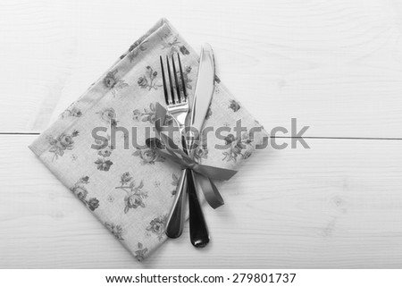 Empty plates and cutlery on table cloth on wooden table for dinner, menu in restaurant Top view horizontally. Flat mock up for design.