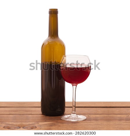 Glass of red wine and bottle on wooden background isolated. Flat mock up for design.