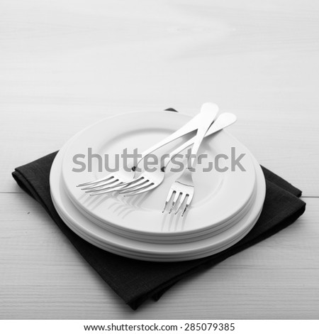 Empty plates and cutlery on table cloth on wooden table for dinner in restaurant. Flat mock up for design menu. Top view.