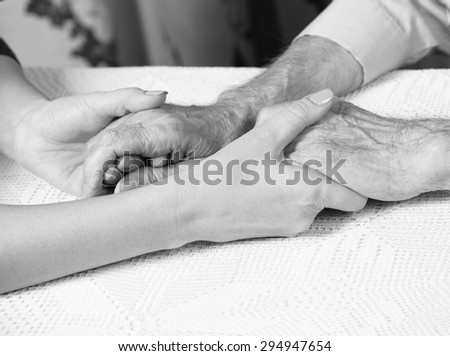 Elderly man. Senior man, woman with their caregiver at home. Concept of health care for elderly old people, disabled. Black and white.