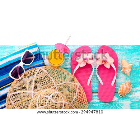 Summer vacation. Pink sandals and beach accessories. Blue wooden texture. Flat mock up for design.
