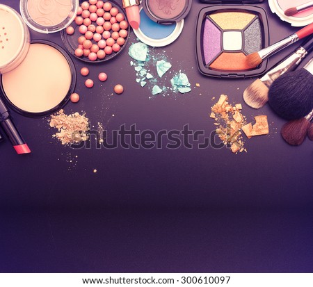 Cosmetics make-up on black background. Top view mock up.