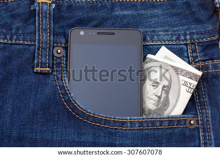 Modern phone in jeans pocket displaying screen. Cash dollars from pocket watch
