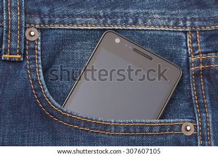 Modern phone in jeans pocket displaying screen.