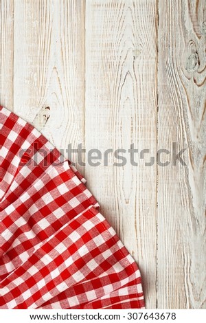 Wood texture background. Wooden table covered with tablecloth cloth checkered plaid red. View from top. Empty tablecloth for product montage for recording menu, recipe. Free space for text, mock up
