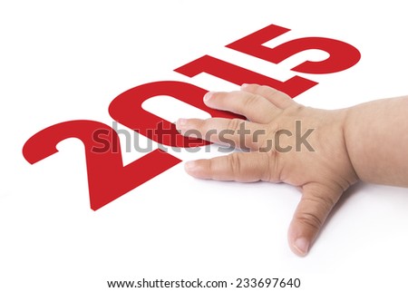 baby\'s hand celebrating 2015 new year on a white background