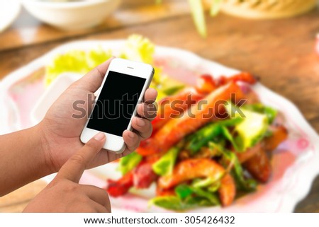 Mobile men and touchscreen smartphone, tablet, mobile phone on the table for lunch.
