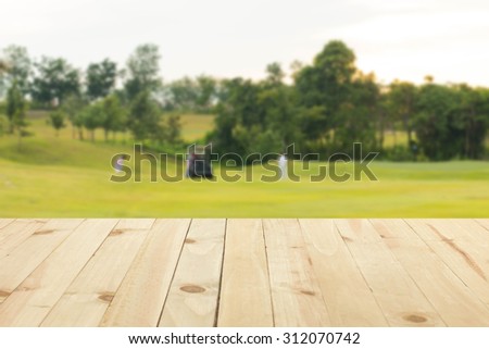 Wooden floor with the background blurred golf course.