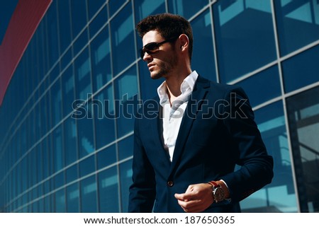 Portrait of an handsome businessman in an urban setting