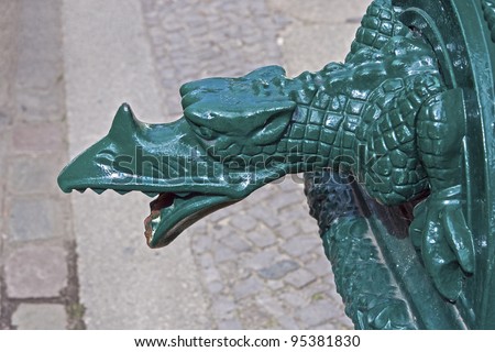 Metal dragon on an old water pump. Shot from Berlin, Germany
