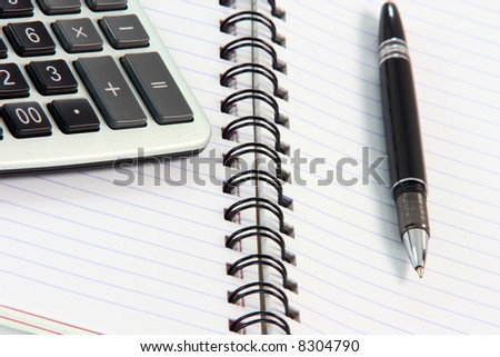 business and office items note book with calculator detail  and black pen
