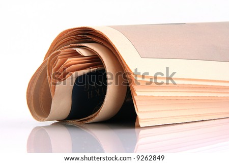 newspaper rolled with reflection isolated on white background media and publications