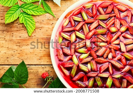 Seasonal pie or cake with rhubarb stalks and raspberries. Summer sweet dessert.Rhubarb tart Stok fotoğraf © 