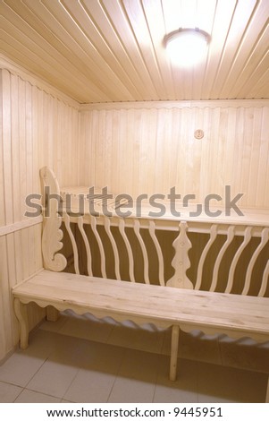 wooden bench of steam room in sauna with beautiful carving