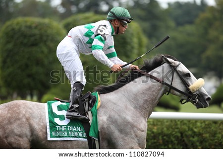 SARATOGA SPRINGS, NY - JULY 28: Jockey Javier Castellano aboard Winter Memories rides out after winning The Diana Stakes on July 28, 2012 Saratoga Springs, New York
