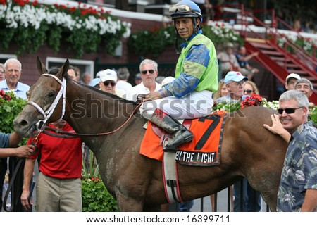 SARATOGA SPRINGS - August 18: Edgar S. Prado aboard by The Light in the Winners Circle after Winning the Union Avenue Stakes August 18, 2008 in Saratoga Springs, NY.