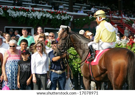 SARATOGA SPRINGS - August 24: Cornellio Velasquez Aboard Lady Rizzi in the Winners Circle After the Seventh race August 24, 2008 in Saratoga Springs, NY.