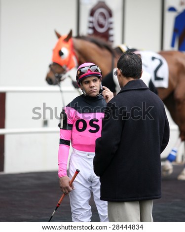 OZONE PARK - APR 4: Jose Sanchez speaks to Trainer Oscar Barrera Jr. prior to the start of the First Race at Aqueduct Race Track- April 4, 2008 in Ozone Park, NY.