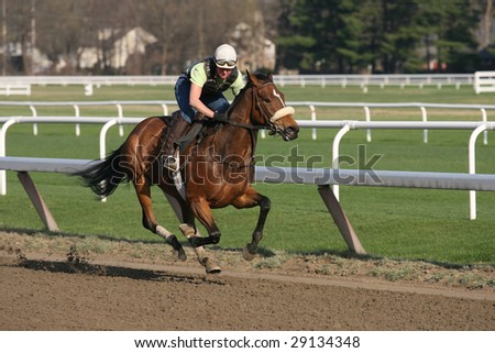 SARATOGA SPRINGS - APR 25: A rider for Jacqueline Racing Stable breezes a horse during the first weekend of the season at the Oklahoma training track- April 25, 2009 in Saratoga Springs, NY.