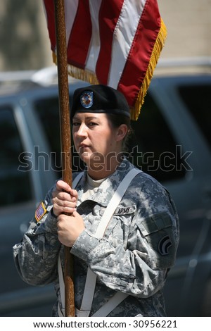 CASTLETON-ON-HUDSON - May 25: A Member of the Army Reserve Proudly Marches with the Flag during the 2009 Castleton-on-Hudson Memorial Day Parade - May 25, 2009 in Castleton-on-Hudson, New York.