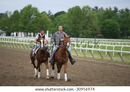 SARATOGA SPRINGS - May 23: Trainer George Weaver escorts a 2 year old and it\'s rider around the track during Memorial Day Weekend at the Oklahoma training track- May 23, 2009 in Saratoga Springs, NY.