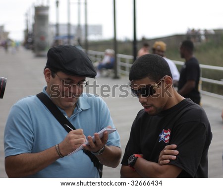 ATLANTIC CITY - JUNE 25: Juan Manuel Lopez the current WBO super bantamweight talks to a reporter after a promotional event on the Boardwalk at Bally\'s Casino - June 25, 2009 in Atlantic City, NJ