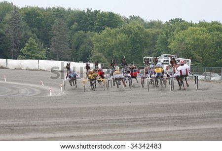 SARATOGA SPRINGS - JULY 26: The field rounds the first turn for the first time in the fifth race at the Saratoga Gaming and raceway on July 26, 2009 in Saratoga Springs, NY