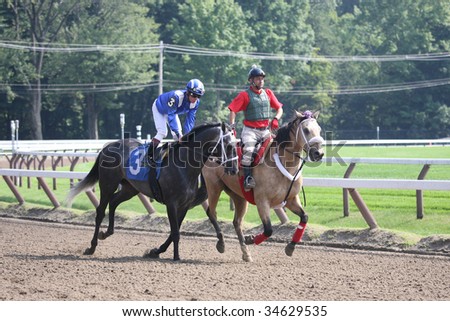 SARATOGA SPRINGS, NY- AUGUST 1:  Michael Luzzi (L) aboard Inti (URU) in the post parade for the 7th race at Saratoga Race Track August 1, 2009 in Saratoga Springs, NY.