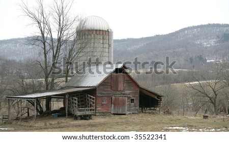 Old run down barn and silo on farm