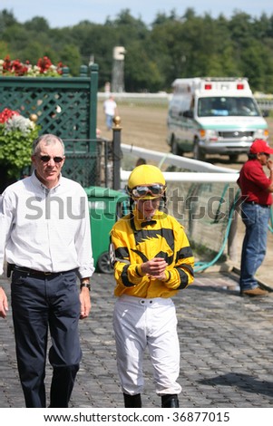 SARATOGA SPRINGS, NY- AUG 28: Julien Leparoux talks to trainer E. Harty in the winners circle after the 3rd race at Saratoga Race Track, August 28, 2009 in Saratoga Springs, NY.