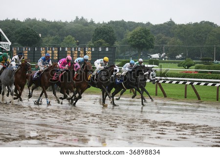 SARATOGA SPRINGS, NY- AUGUST 29: The Field Leaves the gate in the 1st race on a muddy track at Saratoga Race Track, August 29, 2009 in Saratoga Springs, NY.