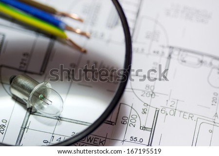 Electrical equipment on house plans under the magnifier.
