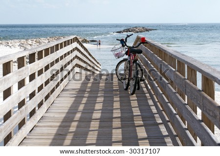 Bikes on a boardwalk leading to the beach on the Alabama/Florida gulf coast.