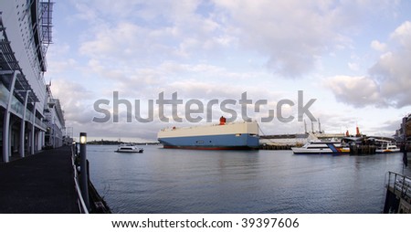 color photo of cargo ships, boats and ferry docked at Princes Wharf in Auckland,New Zealand viewed from a fish eye lens