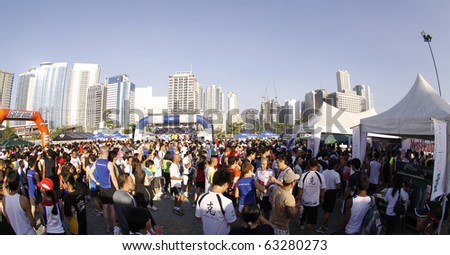 MANILA - APRIL 11: Runners and spectators in Mizuno Infinity 10K  view booths and product exhibits after the race on  April 11,2010 at Global City, Fort Bonifacio, Taguig City, Metro Manila, Philippines