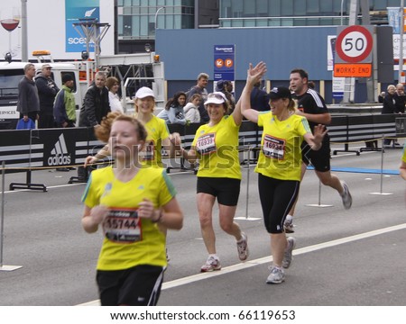 AUCKLAND - OCTOBER 31: Participants in the Adidas Auckland marathon run sprint to the finish line on Sunday Oct. 31,2010 at  Auckland, New Zealand