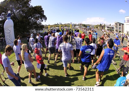 AUCKLAND - MARCH 13: Participants walking to the finish line of Auckland Round the Bays fun walk and run with an estimated 70,000 entrants, in Auckland, New Zealand on Sunday March 13, 2011.