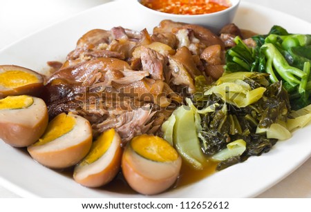 Stewed pork leg with five spices, served with eggs and pickle, Thai cuisine