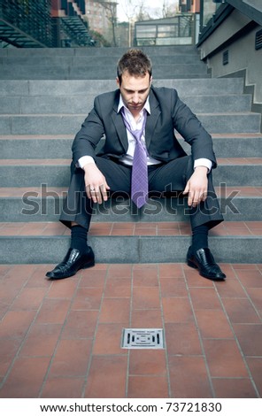 Depressed businessman. All went down the drain concept.
