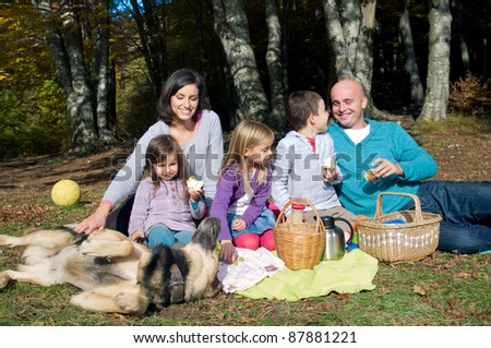 Happy family having picnic in autumn
