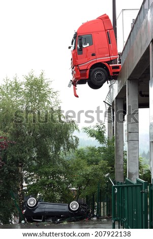 SPA-FRANCORCHAMPS, BELGIUM - JULY 28: Car falls off paddock and truck hangs on the ledge at circuit of Francorchamps on July 28, 2014 in Spa-Francorchamps, Belgium.