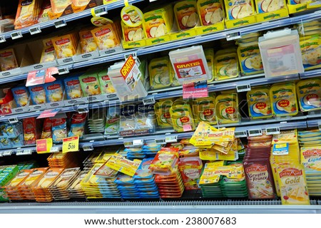 WAVRE, BELGIUM - OCTOBER 17: Refrigerated shelves with cheese at a Carrefour Hypermarket. What is the price trend after the milk quota abolition in 2015?. taken on October 17, 2014 in Wavre, Belgium