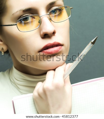 beautiful young business woman with a pad and pen in hand