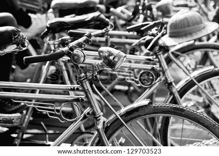 Black and white image of bike taxi parking on the street