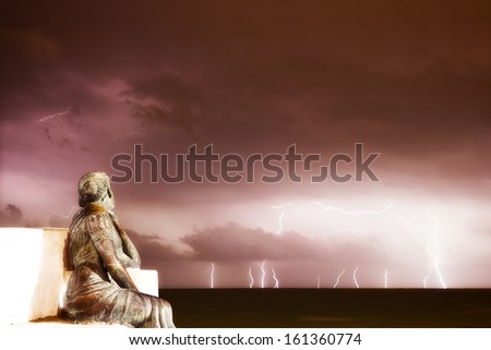 Girl looking a storm at the sea