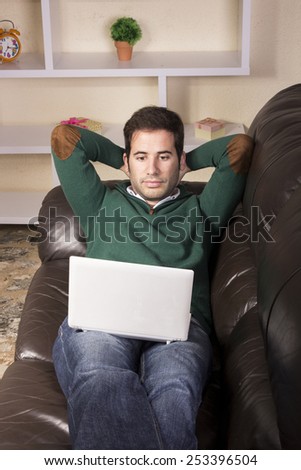 Handsome guy relaxed and using technology on sofa