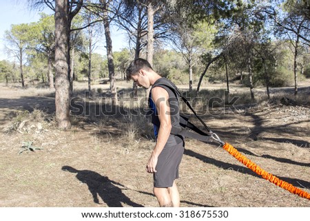 Athletic guy using resistance athletic vest