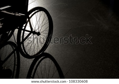 Closeup empty wheelchair on dark background and shadow