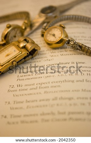 Yellow and white gold ladies watches over quotations about time.